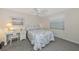 Bedroom featuring beach-themed bedding, white furnishings, and a well-lit desk area at 6796 Gasparilla Pines Blvd # 18, Englewood, FL 34224