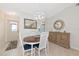 Dining area featuring a modern chandelier, neutral tones, and a view of the kitchen at 6796 Gasparilla Pines Blvd # 18, Englewood, FL 34224