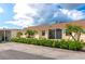 Exterior view of condo units with palm trees and manicured landscaping at 6796 Gasparilla Pines Blvd # 18, Englewood, FL 34224