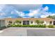 Low-rise condo complex with manicured landscaping, shrubbery, and private parking, inviting curb appeal at 6796 Gasparilla Pines Blvd # 18, Englewood, FL 34224