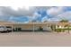 Exterior carport parking for multiple units with yellow doors and manicured landscaping at 6796 Gasparilla Pines Blvd # 18, Englewood, FL 34224