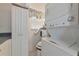 Laundry room with stacked washer/dryer and storage cabinet, maximizing space at 6796 Gasparilla Pines Blvd # 18, Englewood, FL 34224