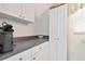Functional laundry area with washer, dryer, and storage cabinets at 6796 Gasparilla Pines Blvd # 18, Englewood, FL 34224
