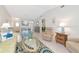 Bright living room featuring tile flooring, vaulted ceilings, and coastal decor at 6796 Gasparilla Pines Blvd # 18, Englewood, FL 34224