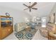 Coastal-themed living room with tile floors, ceiling fan, and a view into the dining area at 6796 Gasparilla Pines Blvd # 18, Englewood, FL 34224