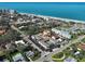 Aerial view of complex near the beach with pool, ample parking and nearby businesses at 701 Barcelona Ave # 101, Venice, FL 34285