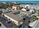 Excellent aerial view of condo complex and sparkling pool with nearby beach and coastal surroundings at 701 Barcelona Ave # 101, Venice, FL 34285