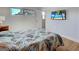 Comfortable bedroom featuring a palm leaf patterned bedspread and entertainment center at 701 Barcelona Ave # 101, Venice, FL 34285