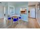 Bright dining area with a view into the kitchen and a round mirror on the wall at 701 Barcelona Ave # 101, Venice, FL 34285