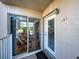 Condo unit entrance shows the patio room with comfortable chairs beyond sliding glass doors, as well as the front door at 701 Barcelona Ave # 101, Venice, FL 34285