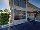 Beige two-story home with many windows, complemented by well-manicured landscaping and a paved parking area at 701 Barcelona Ave # 101, Venice, FL 34285