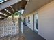 Exterior view of a unit's hallway with patterned concrete block and convenient stair access at 701 Barcelona Ave # 101, Venice, FL 34285