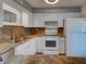Well-equipped kitchen with stainless steel sink and white appliances at 701 Barcelona Ave # 101, Venice, FL 34285