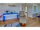 Comfortable living room area with a modern blue table and swivel recliner at 701 Barcelona Ave # 101, Venice, FL 34285