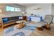 Bright living room with contemporary decor, hardwood floors, a comfortable sofa and a stylish accent rug at 701 Barcelona Ave # 101, Venice, FL 34285