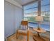 Inviting patio room boasts a comfortable chair, a side table and windows with sun-filtering blinds at 701 Barcelona Ave # 101, Venice, FL 34285