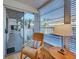 Bright patio room featuring a comfortable chair, a side table and sliding glass doors to the outside at 701 Barcelona Ave # 101, Venice, FL 34285