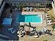Relaxing courtyard featuring a pool, lounge chairs, palm trees, and outdoor seating at 701 Barcelona Ave # 101, Venice, FL 34285