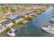 Aerial view of a waterfront home with a pool, dock, and boat lift with canal access at 731 Flamingo Dr, Apollo Beach, FL 33572