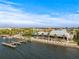 Waterfront view with palm trees, pier, and quaint restaurants in a tropical community under a bright blue sky at 731 Flamingo Dr, Apollo Beach, FL 33572