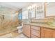 Elegant bathroom featuring dual glass vessel sinks, granite countertops, and a tiled glass shower at 731 Flamingo Dr, Apollo Beach, FL 33572