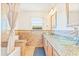 Bathroom featuring dual glass vessel sinks, granite countertops, and a tiled shower with a bench at 731 Flamingo Dr, Apollo Beach, FL 33572