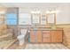Elegant bathroom featuring dual glass vessel sinks, granite countertops, and a tiled glass shower at 731 Flamingo Dr, Apollo Beach, FL 33572
