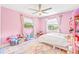 Pink-themed bedroom with bed, large windows, ceiling fan and colorful decorations at 731 Flamingo Dr, Apollo Beach, FL 33572