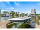 View of boat lift, canal, and waterfront properties on a sunny day at 731 Flamingo Dr, Apollo Beach, FL 33572