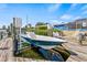 Boat lift with boat, adjacent to the canal, with seating area nearby at 731 Flamingo Dr, Apollo Beach, FL 33572