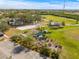 Wide aerial showcasing a community park with beach volleyball, gardens, and green lawns at 731 Flamingo Dr, Apollo Beach, FL 33572