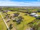 Aerial shot showcasing the community dog park with green lawns and trees under a bright blue sky at 731 Flamingo Dr, Apollo Beach, FL 33572