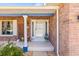 Inviting front porch with brick accents, a decorative column, and stylish decor at 731 Flamingo Dr, Apollo Beach, FL 33572
