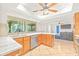 Spacious kitchen featuring an island with bar seating, stainless steel appliances, and a view to the living room at 731 Flamingo Dr, Apollo Beach, FL 33572