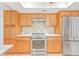 Kitchen featuring updated stainless steel appliances, custom cabinetry, tile backsplash and marble countertops at 731 Flamingo Dr, Apollo Beach, FL 33572
