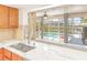 Kitchen sink featuring a window with views of the pool and canal at 731 Flamingo Dr, Apollo Beach, FL 33572