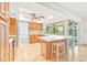 Bright kitchen featuring an island with bar seating, modern appliances, and a view to the pool through the sliding glass door at 731 Flamingo Dr, Apollo Beach, FL 33572