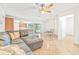 Open-concept living room featuring a sectional sofa, dining area, and view to the kitchen with modern appliances at 731 Flamingo Dr, Apollo Beach, FL 33572