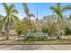 View of Apollo Beach Park sign and entrance lined with beautiful palm trees and shrubs at 731 Flamingo Dr, Apollo Beach, FL 33572