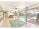 Enclosed patio featuring tile flooring, ceiling fans, and a view to the canal and pool at 731 Flamingo Dr, Apollo Beach, FL 33572