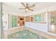 Covered patio featuring tile flooring, ceiling fans, and access to the pool area at 731 Flamingo Dr, Apollo Beach, FL 33572