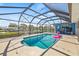 Relaxing pool area with a pink flamingo floatie, grilling area, and views of the canal at 731 Flamingo Dr, Apollo Beach, FL 33572