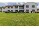 Lush backyard with green grass and manicured shrubs at 800 Capri Isles Blvd # 124, Venice, FL 34292