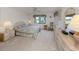 Comfortable bedroom with soft lighting, neutral tones, and views of the community at 800 Capri Isles Blvd # 124, Venice, FL 34292