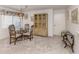 Dining room with glass table and ornate wooden chairs at 800 Capri Isles Blvd # 124, Venice, FL 34292