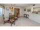 Cozy dining area features a glass table, ornate chandelier, and an open layout at 800 Capri Isles Blvd # 124, Venice, FL 34292