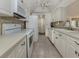 Well-equipped kitchen with white cabinets, modern appliances, and an efficient layout at 800 Capri Isles Blvd # 124, Venice, FL 34292