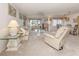 Bright living room featuring neutral walls, carpet and furniture at 800 Capri Isles Blvd # 124, Venice, FL 34292