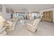 Spacious living area with neutral decor, large windows, and open access to the dining area at 800 Capri Isles Blvd # 124, Venice, FL 34292