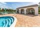 Enjoy the clubhouse by the pool and spa with outdoor seating on the beautiful brick paver deck at 800 Capri Isles Blvd # 124, Venice, FL 34292